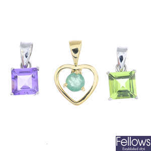Four gem-set pendants.