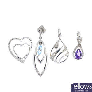 Four diamond and gem-set pendants.