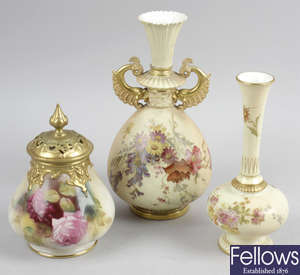 A Royal Worcester bone china vase with gilded pierced cover, a Royal Worcester twin handled vase, (a/f), and another Royal Worcester vase, (a/f).