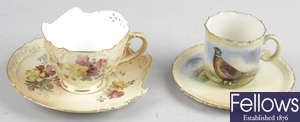 A Royal Worcester bone china cup and saucer, together with a Locke & Co Worcester bone china cup and saucer.