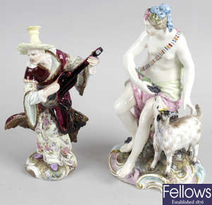 A Berlin porcelain figure group, a German porcelain figure, and a bone china twin handled cup and saucer.