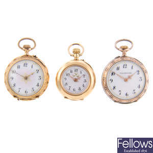 A yellow metal open face fob watch with another yellow metal fob watch and a white metal fob watch.