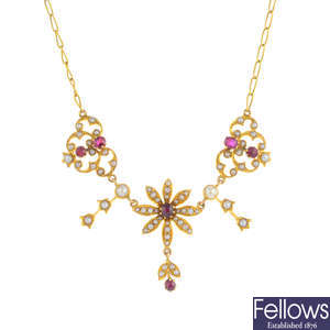 An early 20th century gold, ruby and split pearl floral necklace.