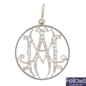 An early 20th century platinum and gold diamond monogram pendant.