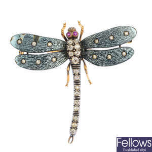 An early 20th century silver and gold, ruby, diamond and enamel dragonfly brooch.