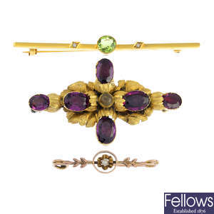Three late Victorian and early 20th century gold garnet, seed pearl and peridot brooches.