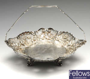 A Victorian silver pierced & embossed dish with swing handle.