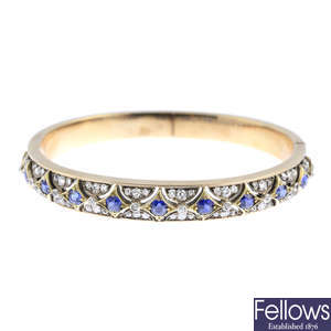 A late Victorian gold sapphire and diamond hinged bangle.