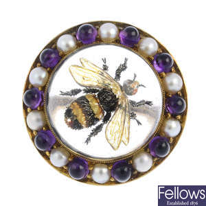 CARLO GIULIANO - a late Victorian 18ct gold amethyst and split pearl reverse-carved intaglio bumble bee brooch.