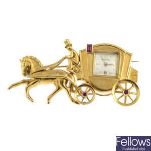 BUCHERER - a mid 20th century ruby horse and carriage watch brooch.