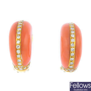 A pair of coral and diamond earrings.