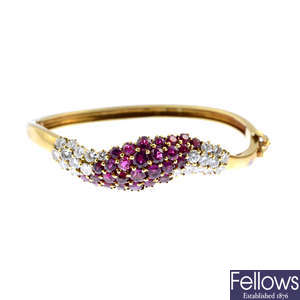 A 1970s 18ct gold ruby and diamond hinged bangle.