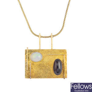 A 14ct gold opal and garnet pendant, on 9ct gold chain.