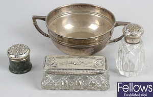 A Sheffield 1944 hallmarked silver twin handled dish, sterling silver topped glass pepper pot, hallmarked silver lidded dressing table jar, etc.