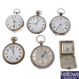 A group of five assorted pocket watches and a travel clock.