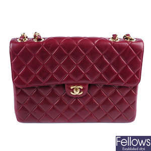 CHANEL - a burgundy Jumbo Classic Flap handbag.