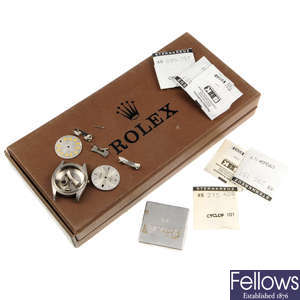 ROLEX - a group of assorted watch dials, crowns, glasses, a stainless steel watch case and storage box.
