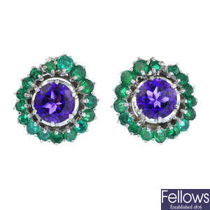 A pair of emerald and amethyst earrings.