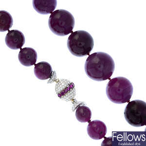 A pink sapphire bead necklace with diamond and ruby clasp.