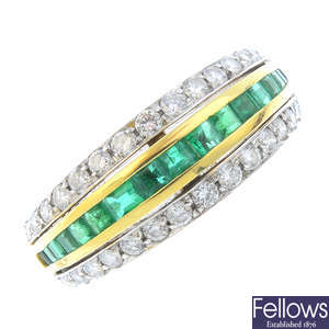 An 18ct gold gold emerald and diamond dress ring.