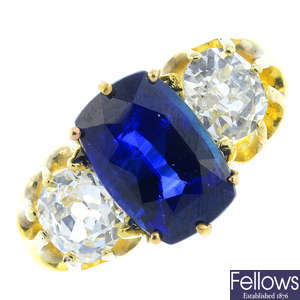 A sapphire and diamond three-stone ring.