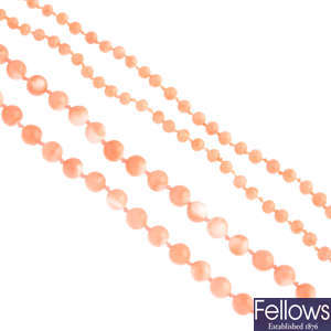 Four coral bead single-strand necklaces.