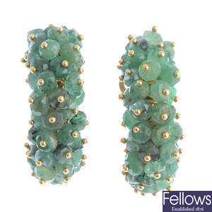 A pair of emerald hoop earrings.