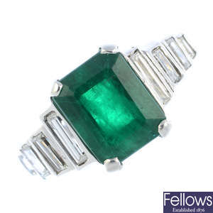 A platinum emerald and diamond ring.