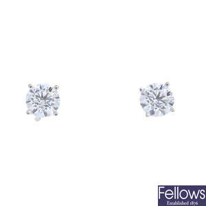 A pair of brilliant-cut diamond earrings.