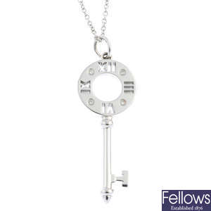 TIFFANY & CO. - a diamond 'Atlas' key pendant, with chain.