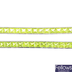 Seven green cubic zirconia bracelets.
