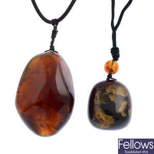 Two natural amber pendants.