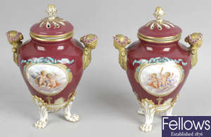 A pair of Sevres porcelain urns with associated covers.