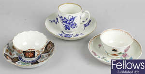 Two 18th century Worcester tea bowls, a collection of other tea cups and saucers, and a small blue and white leaf shaped dish.