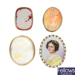 Three cameo brooches and a porcelain brooch.