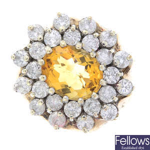 A citrine and diamond floral cluster ring.