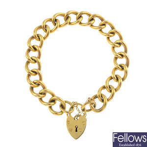 A 9ct gold curb-link bracelet, with heart-shape padlock clasp.