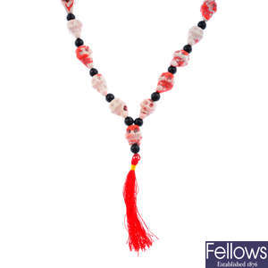 A coral and paste skull necklace.