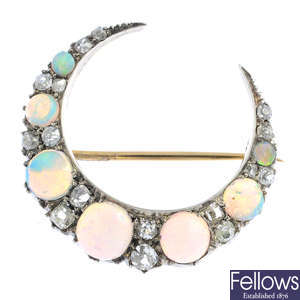 A late Victorian silver and gold opal and diamond crescent brooch.