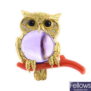 An 18ct gold amethyst, coral, diamond and onyx owl brooch, by E Wolfe & Co.