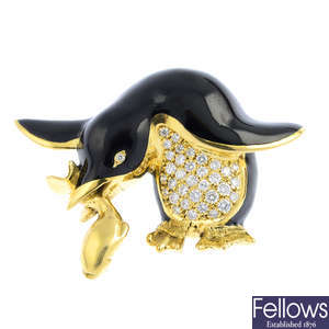 GARRARD - an 18ct gold diamond and enamel penguin brooch.