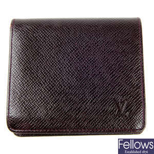 LOUIS VUITTON - a brown Taiga Bifold wallet.