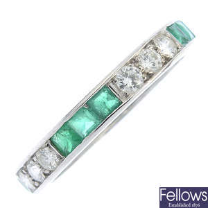An emerald and diamond full eternity ring.