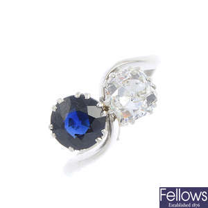 A diamond and sapphire two-stone crossover ring.