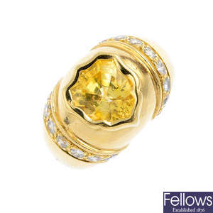 A yellow sapphire and diamond ring.