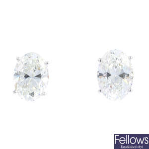 MOUSSAIEFF - a pair of oval-shape diamond stud earrings.