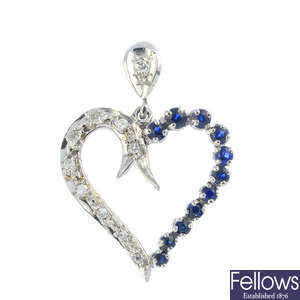 A diamond and sapphire heart pendant.