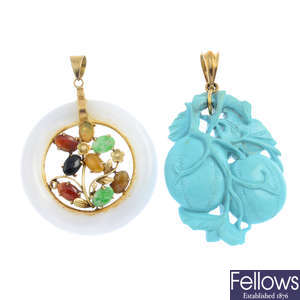 Two gemstone pendants.