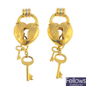 A pair of heart and key earrings.