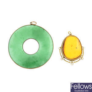 A amber pendant and a jade bi pendant.